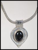 A stamped 925 silver tribal style necklace with a