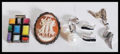 A silver collared cameo brooch depicting the three