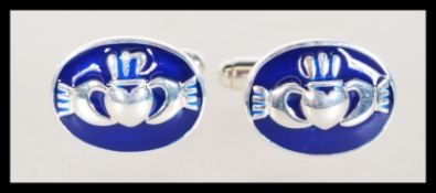 A pair of sterling silver and enamel set cufflinks
