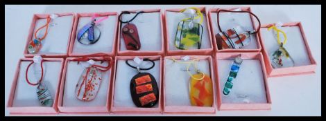 A selection of art glass pendants of different col