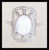 A sterling silver CZ dress ring having a central o