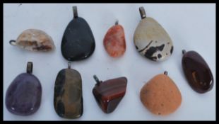A selection of eight precious stone pendants to in