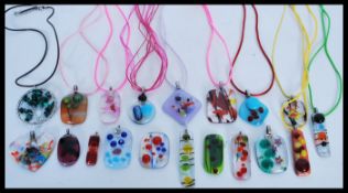 A selection of art glass pendants of different col