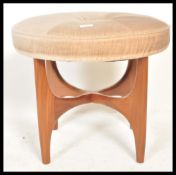 A retro 20th century teak wood circular G-Plan dressing table stool raised on teak wood x-cross base