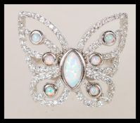 A sterling silver marcasite ring in the form of a butterfly having central opal panel. Weighs 6