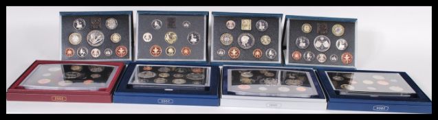 A collection of eight cased uncirculated British coins sets, all in original cases and outer boxes.
