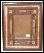 A late 19th / early 20th Indian Anglo Colonial picture frame, the carved hardwood wooden frame