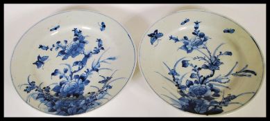 A pair of 19th Century Japanese Arita ware blue and white charger plates having hand painted