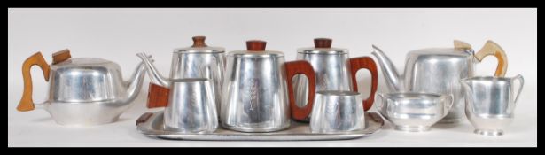 A collection of vintage retro 20th Century piquet ware stainless steel ware having teak wooden