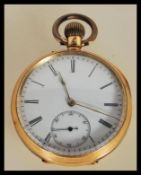 An 18t gold open faced crown winder pocket watch with enamel dial, roman numeral chapter ring with