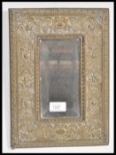 A late 19th Century Victorian brass framed wall mirror in the Art Nouveau taste,the brass frame