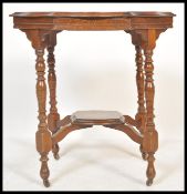 A 19th Century Victorian centre table having a round top with shaped edges, raised on four turned