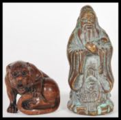 An early 20th Century Chinese bronze of a scholar together with a carved wooden netsuke of a tiger