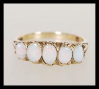A hallmarked 9ct gold five stone opal ring having a graduating group of five opal panels in