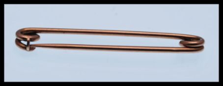 A 9ct gold ( stamped 9ct ) safety pin / brooch safety pin / brooch in the form of a safety pin, in