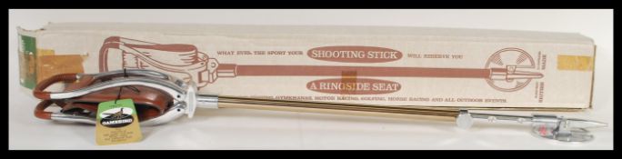 A vintage boxed brown leather and white metal shooting stick. 91cm long.