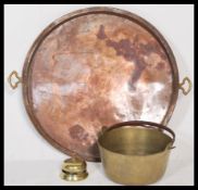 A 19th Century large copper pan tray with riveted brass handles along with a brass jam preserve