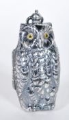 A silver plated sovereign vase with the form of an owl having yellow glass eyes with bale hoop to
