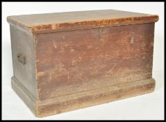 A 19th Century pine trunk coffer chest box having wrought iron drop handles and having painted