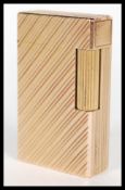 A vintage yellow metal Dupont of Paris gentleman's cigarette lighter having Chevron design with