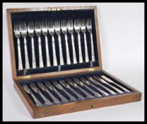 A vintage early 20th Century silver plated canteen of cutlery in oak case consisting of twelve