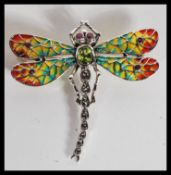 A large sterling silver plique a jour brooch in the form of a dragonfly with large faceted peridot