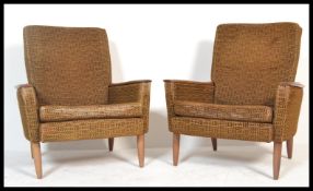 A  pair of retro 1960's armchairs in the manner of Greaves and Thomas, Raised on teak shaped