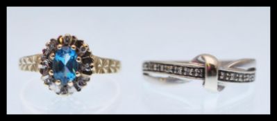 Two hallmarked 9ct gold ring to include a gold ring set with an oval cut blue stone and a halo of