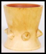 A 19th Century Ivory inverted conical egg cup, the lower half having a series of six pointed