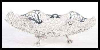 A 20th Century hallmarked silver pierced bon bon dish by R Hood & Son raised on three claw feet with