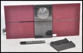 A retro Bang & Olufsen Beosound 2000 CD Cassette Radio Tuner with burgundy coloured speakers.