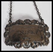 A 20th century silver hallmarked decanter label, having graved notation reading whisky, with