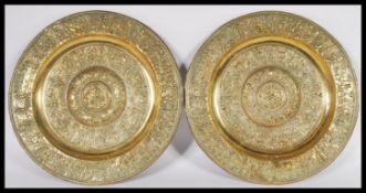 A pair of reproduction 19th Century gilt bronze heavy wall chargers of circular form having relief
