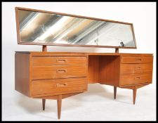 A retro 20th Century teak wood kneehole twin pedestal dressing table, full length framed mirror to