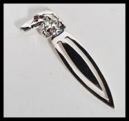 A sterling silver bookmark clip in the form of a dogs head with red stone set eye.