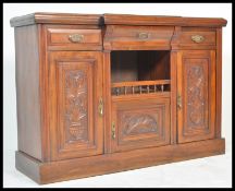 A 19th Century Victorian Art Nouveau circa 1890 walnut breakfront sideboard credenza having a
