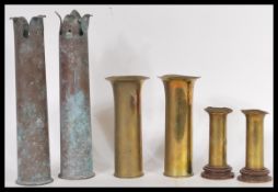 A collection of vintage early 20th Century trench art modelled from artillery shells, the shells