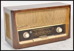 A vintage 20th Century walnut cased Grundig AM / FM valve radio. Model No 3028. Dials and controls