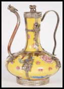 A 20th Century Chinese / Tibetan famille Jaune teapot having silver white metal mounts depicting