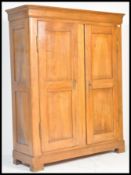 A 19th century French provincial walnut triple armoire. The upright body with twin full length panel