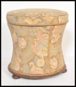 A 19th Century mahogany based pinched cylinder ottoman stool of wasted form having floral chintz