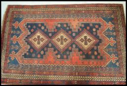 A large 20th Century wool Persian Sorjan region floor carpet rug having a red ground with