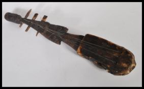 Tribal Art - a vintage 20th Century African Adungu-type string instrument fitted with three strings,