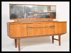 A retro 20th Century teak wood dressing table, central bank of two long graduating drawers flanked