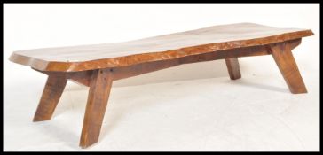 A retro 20th century live edge coffee table the full grain show wood surf board shape top raised