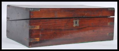 A early 19th century Georgian mahogany writing slope box. The inlaid hinged lid opening to reveal