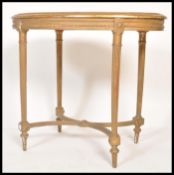 A 19th Century French gilt ormolu wooden table of octagonal form raised on reeded column legs with X