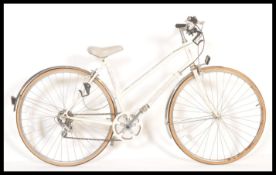 A 1980's ladies Falcon ' Paris ' bicycle in white colourway with the original decals, saddle and