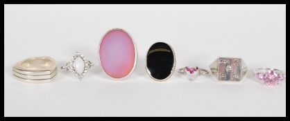 A selection of stamped 925 silver rings to include a dress ring set with three pink stones, a ring