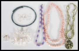 A collection of pearl jewellery to include a selection of colours and shapes including a green